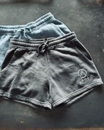two pairs of shorts with embroidery logos on them
